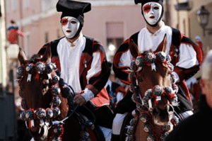 2 horseback riders in doll masks during the festival of Sa Sartiglia in Sicily