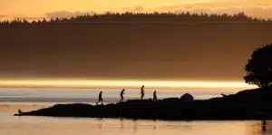 group hiking at sunset in San Juan Islands