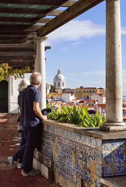 Couple looks over coastal city in Portugal