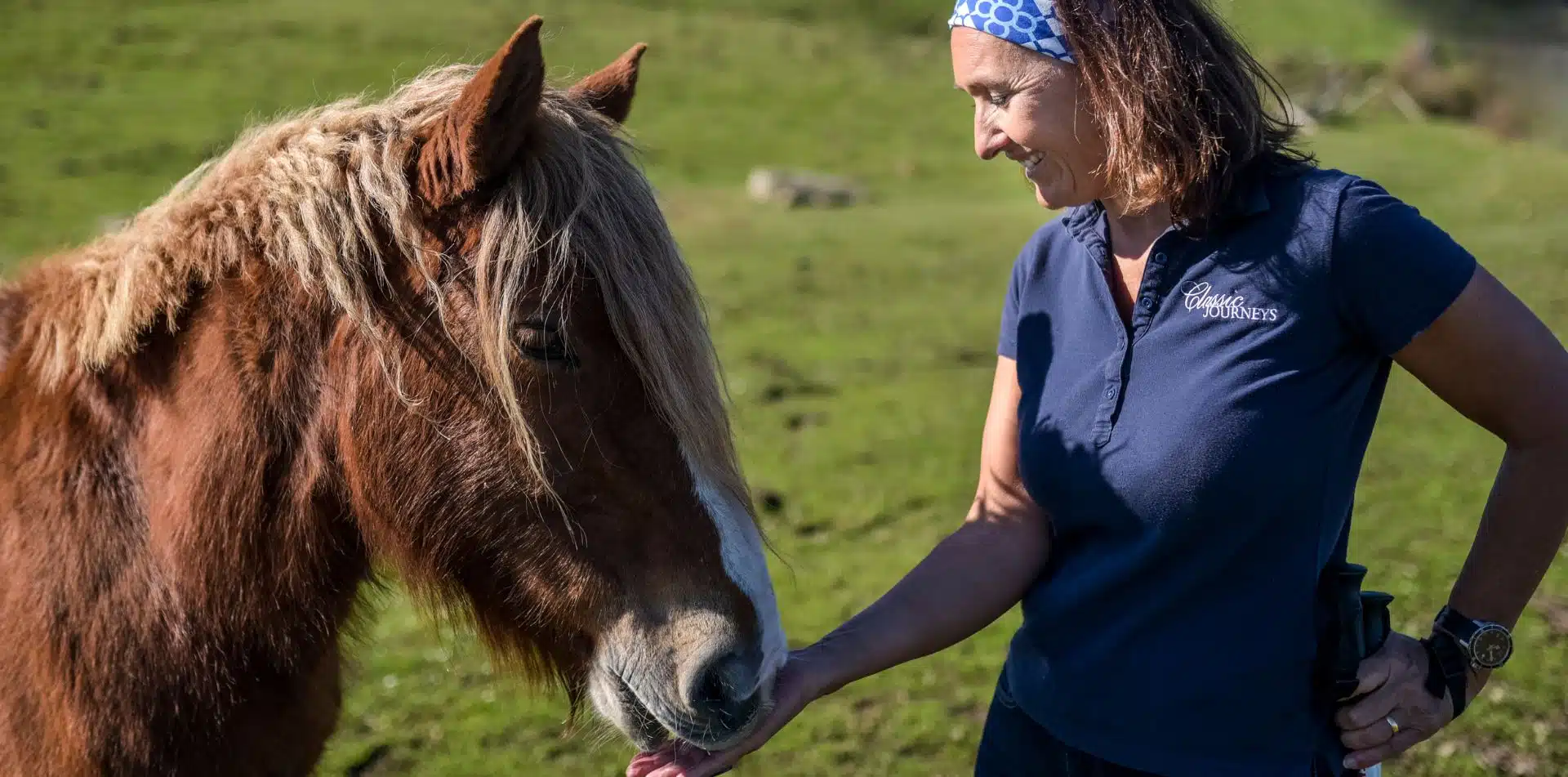 Classic Journeys' guide feeding a horse in Basque