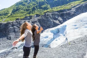 2 women in front of Exit Glacier in Alaska