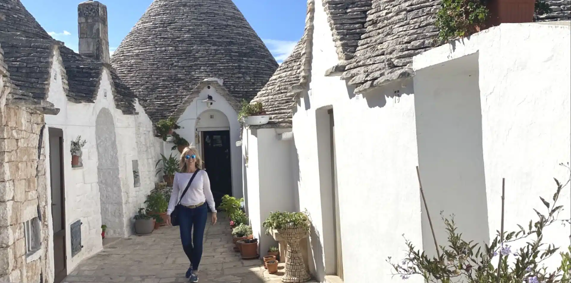 Traveler walking among trulli in Puglia, Italy