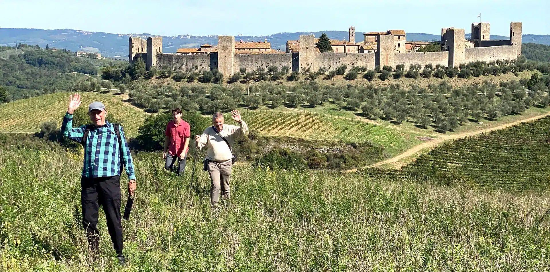 Travelers walking to Monteriggioni, a walled town in Tuscany, Italy