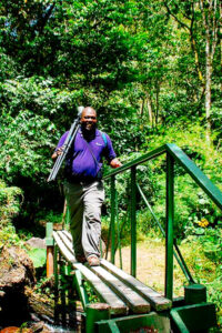 Beny tour guide walking over a bridge.