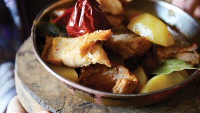 A bowl with grilled chicken and fruit