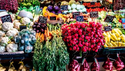 An open market showing various colorful vegetables.