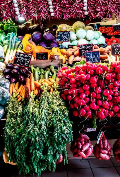 An open market showing various colorful vegetables.