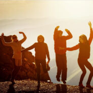 Young people dancing at sunset.