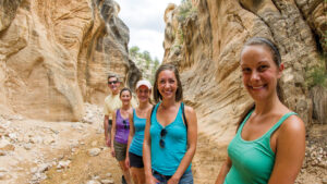Women taking a selfie with her family in a canyon.