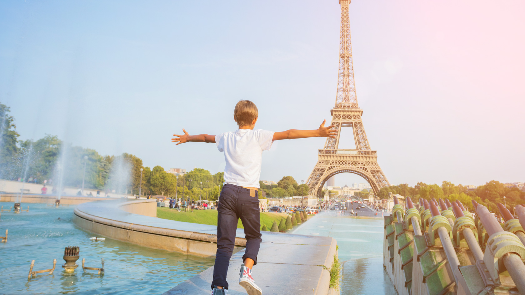 Boy running towards the Eiffel Tower in Paris