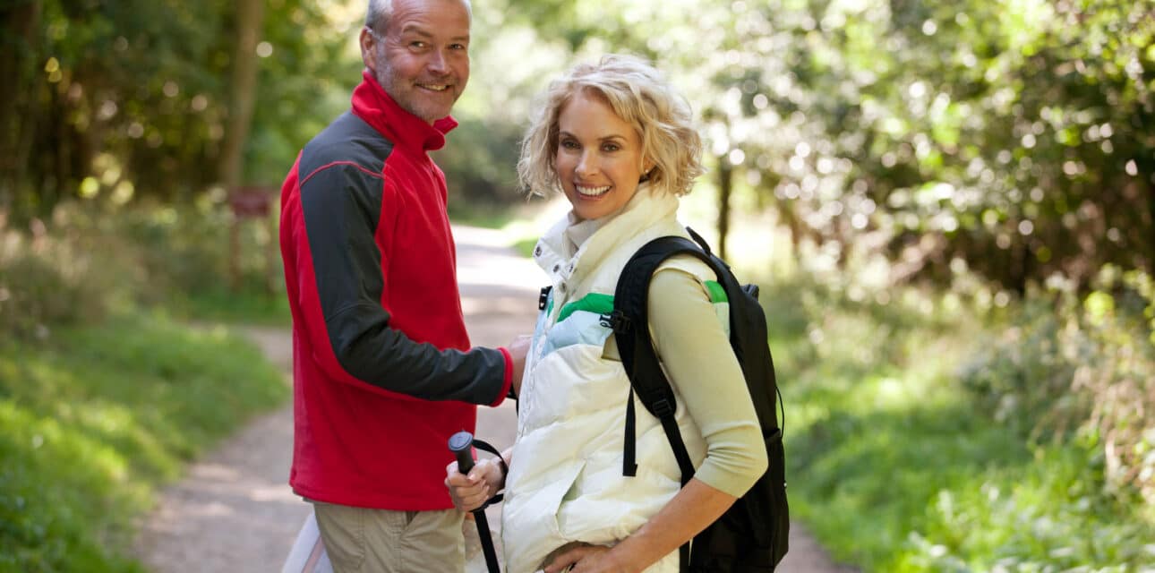 An elder couple hiking.