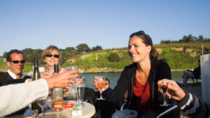 Women clinking glasses on he French river.