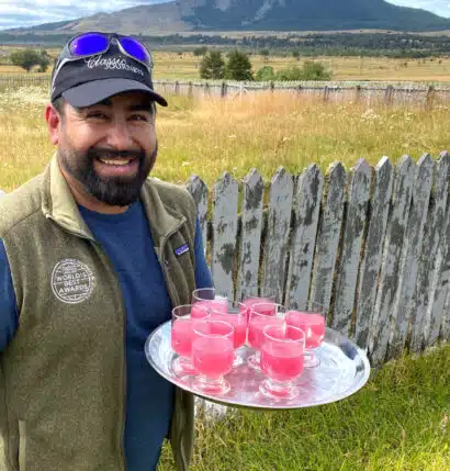 A local guide holding a tray with drinks.