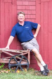 Michael guide leaning on a barn.