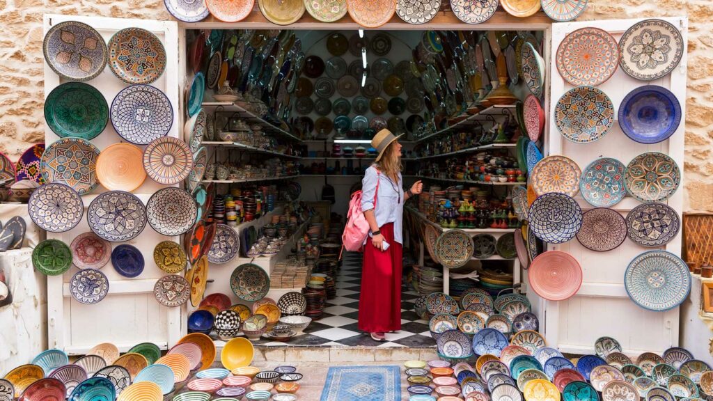 Traveler exploring a small outdoor shop in Fes Morocco
