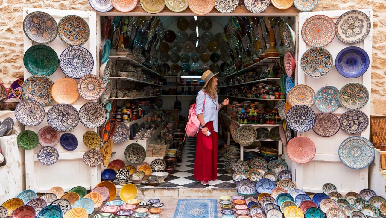Traveler exploring a small outdoor shop in Morocco