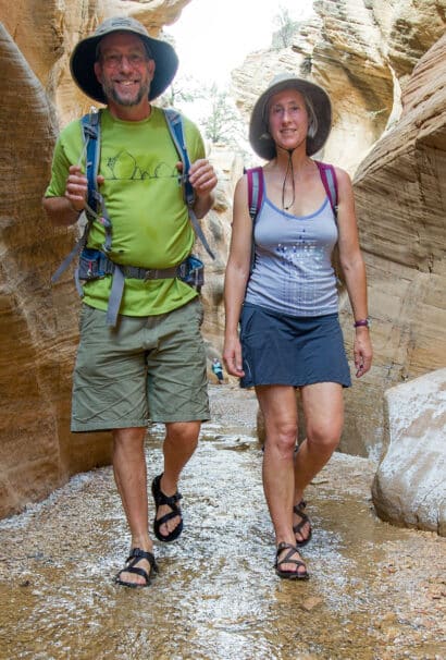 A couple walking through canyon.