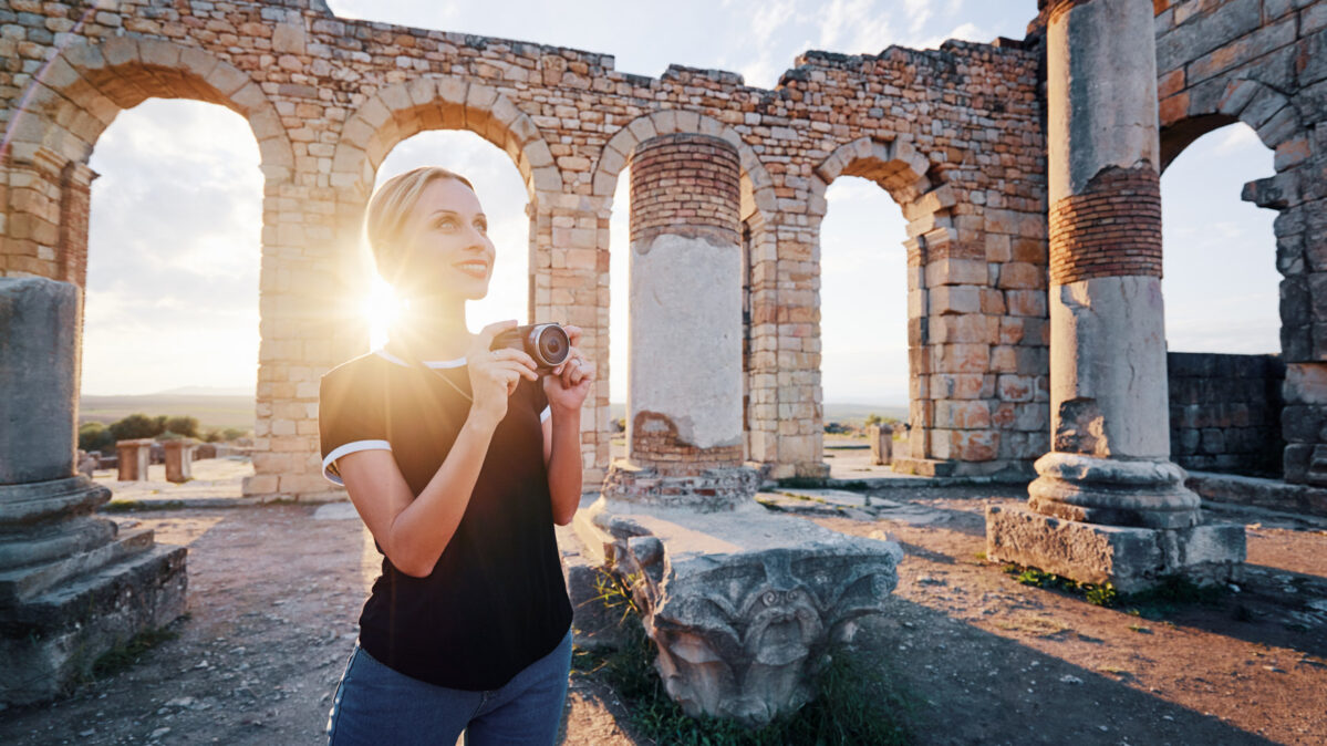 Girl taking a picture at sunset.