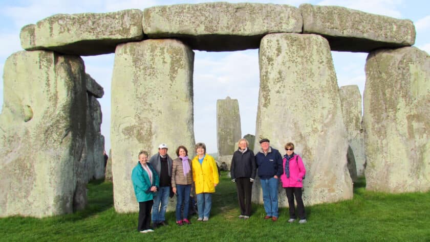 A group of tourists in front of Stonehenge.