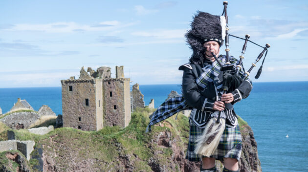 A man playing the Bagpipes.