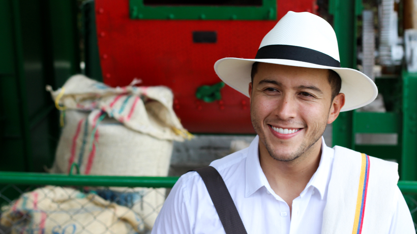 A young man smiling.