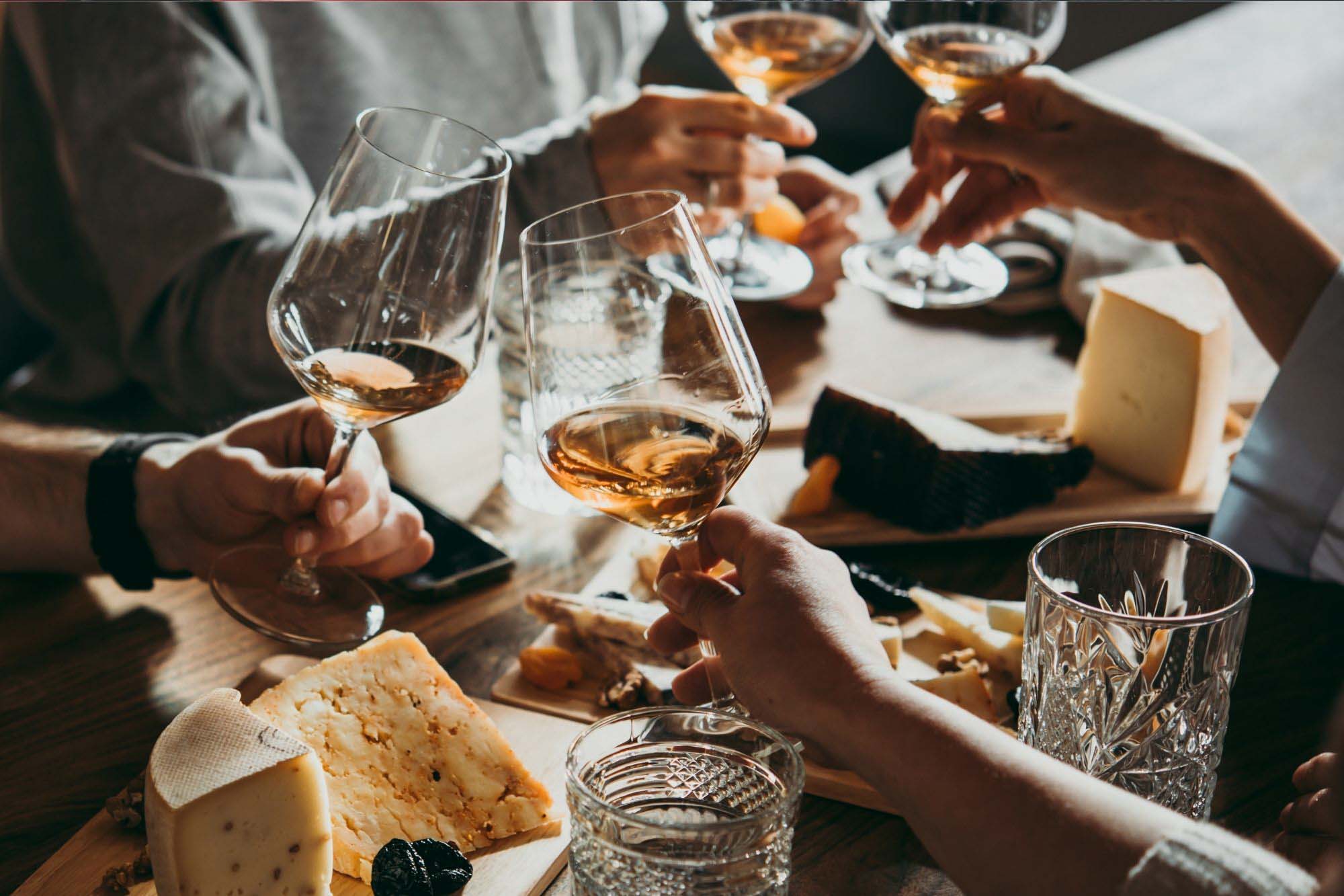 A group of people clinking wine glasses.