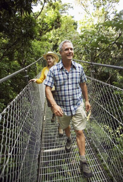 Costa Rice Man and Woman walking on a hanging bridge