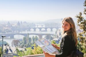 Woman overlooking the skyline of Prague on a sunny day