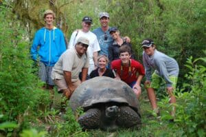 family around a Galapagos Turtle