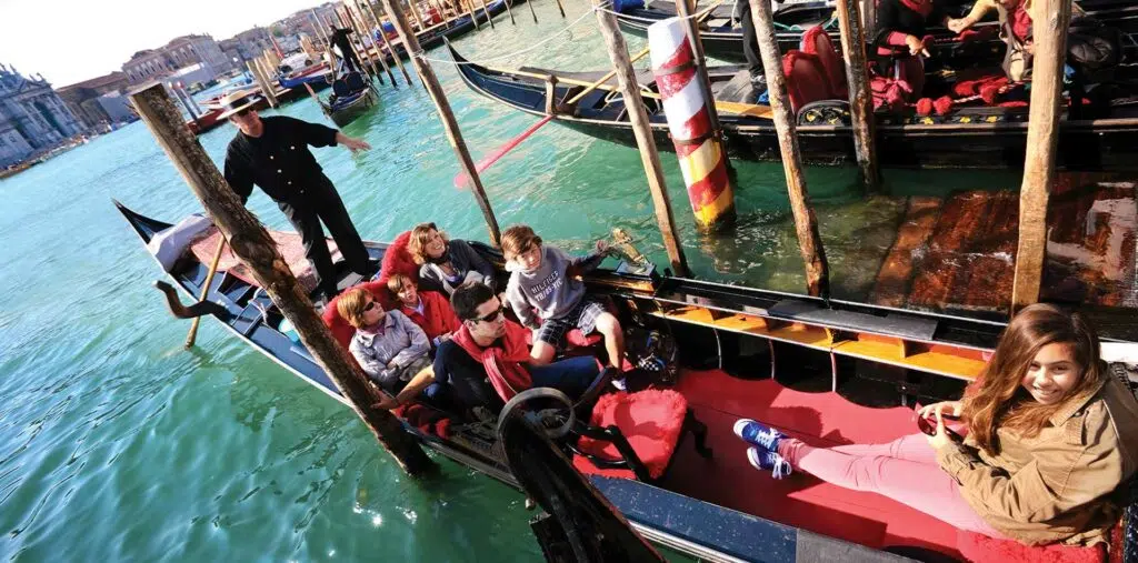 A family enjoys a gondola ride in Venice Italy