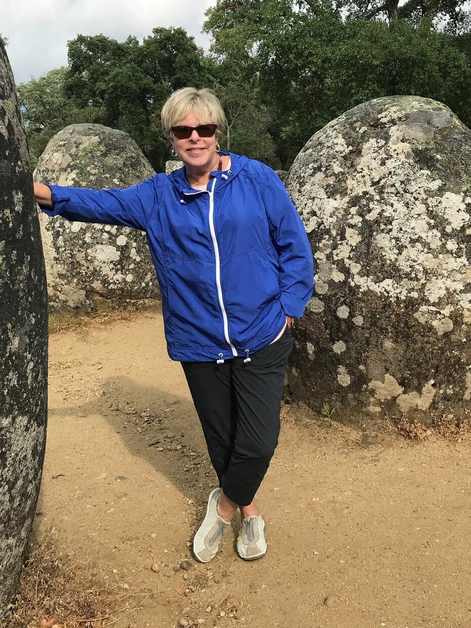 A traveler stands at Almendres Cromlech, Portugal's Stonehenge