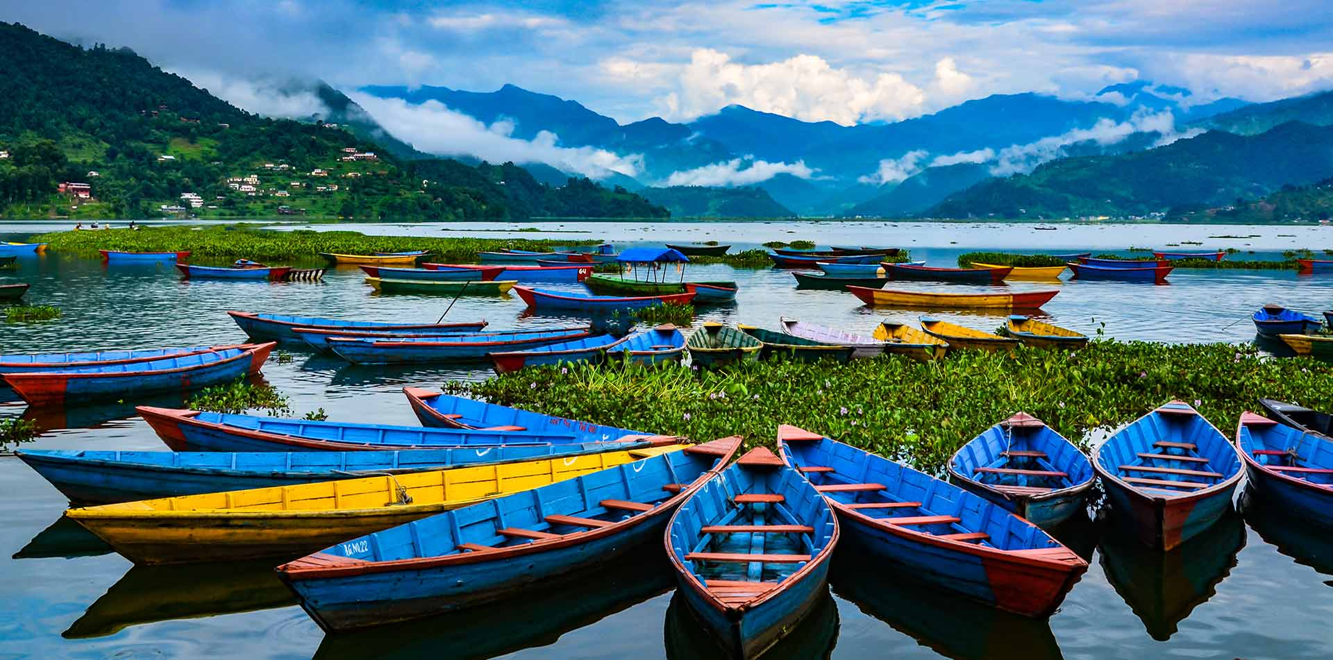 Colorful row boats docked on lake