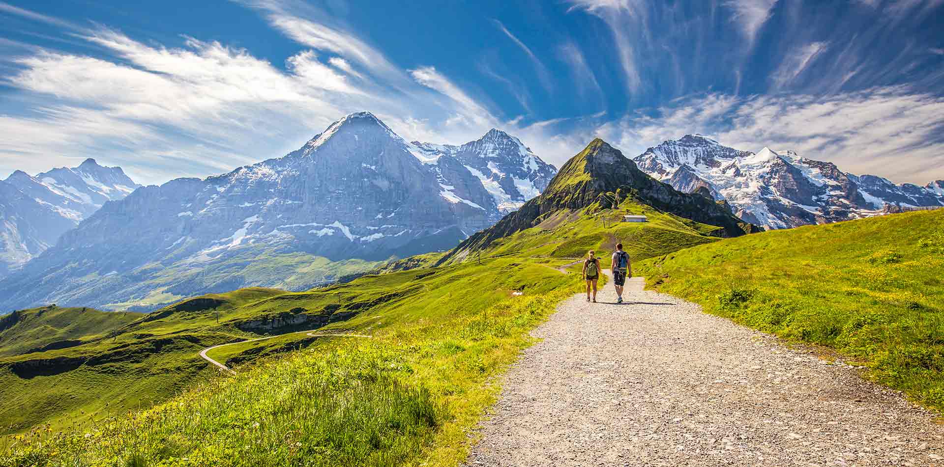 Couple hiking a trail, Swiss Alps