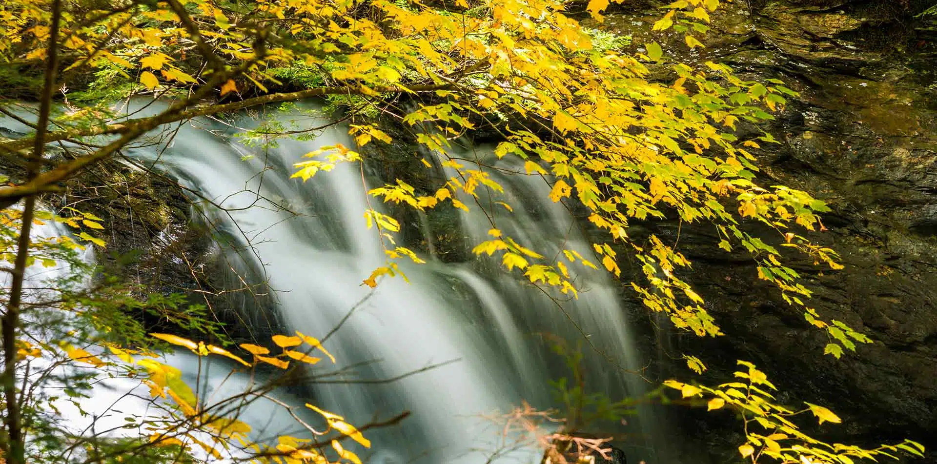North America United States Vermont Stowe beautiful Bingham Falls colorful yellow fall leaves - luxury vacation destinations