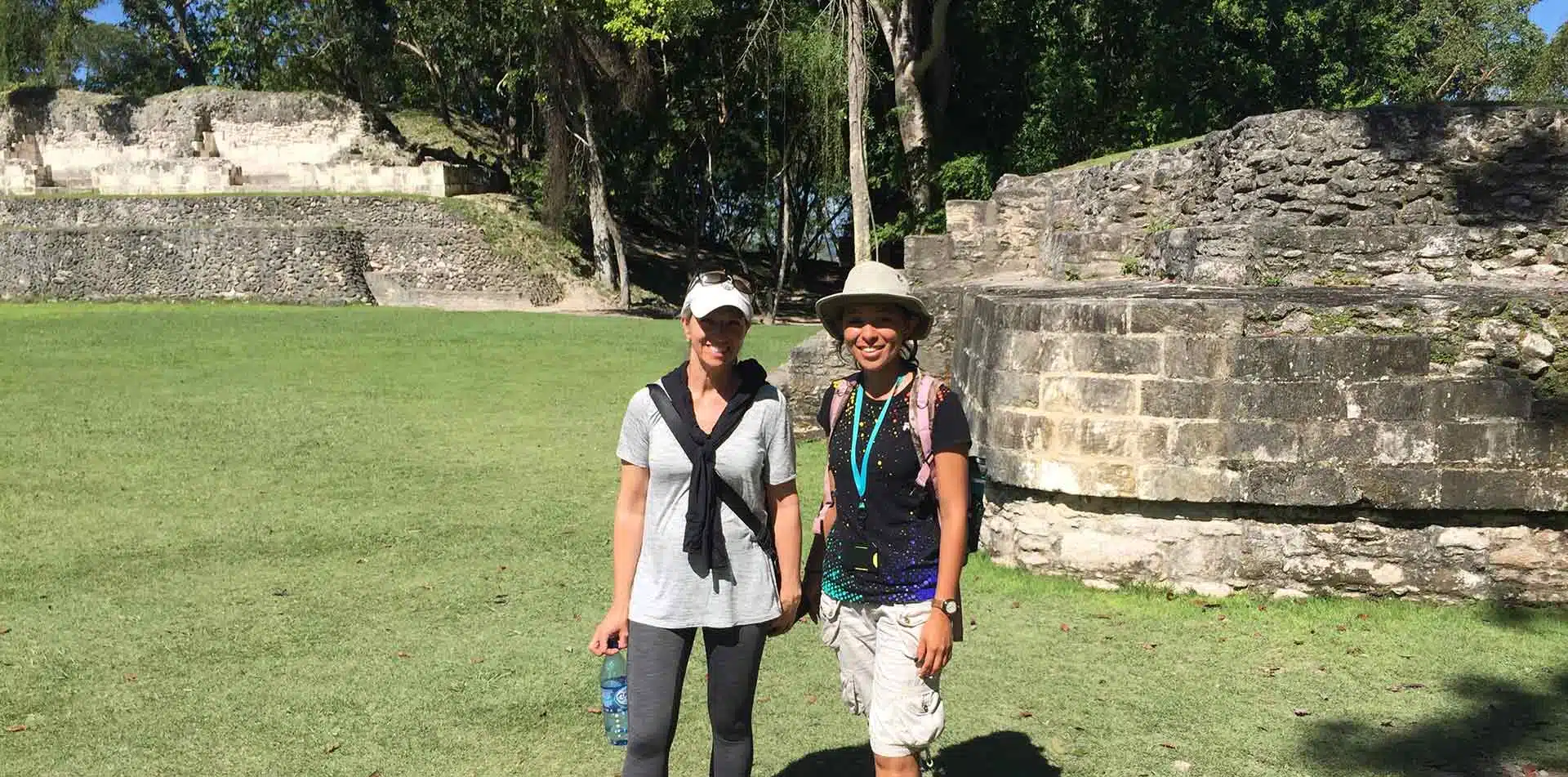 Central America Belize women smiling ancient Mayan ruins historical architecture - luxury vacation destinations