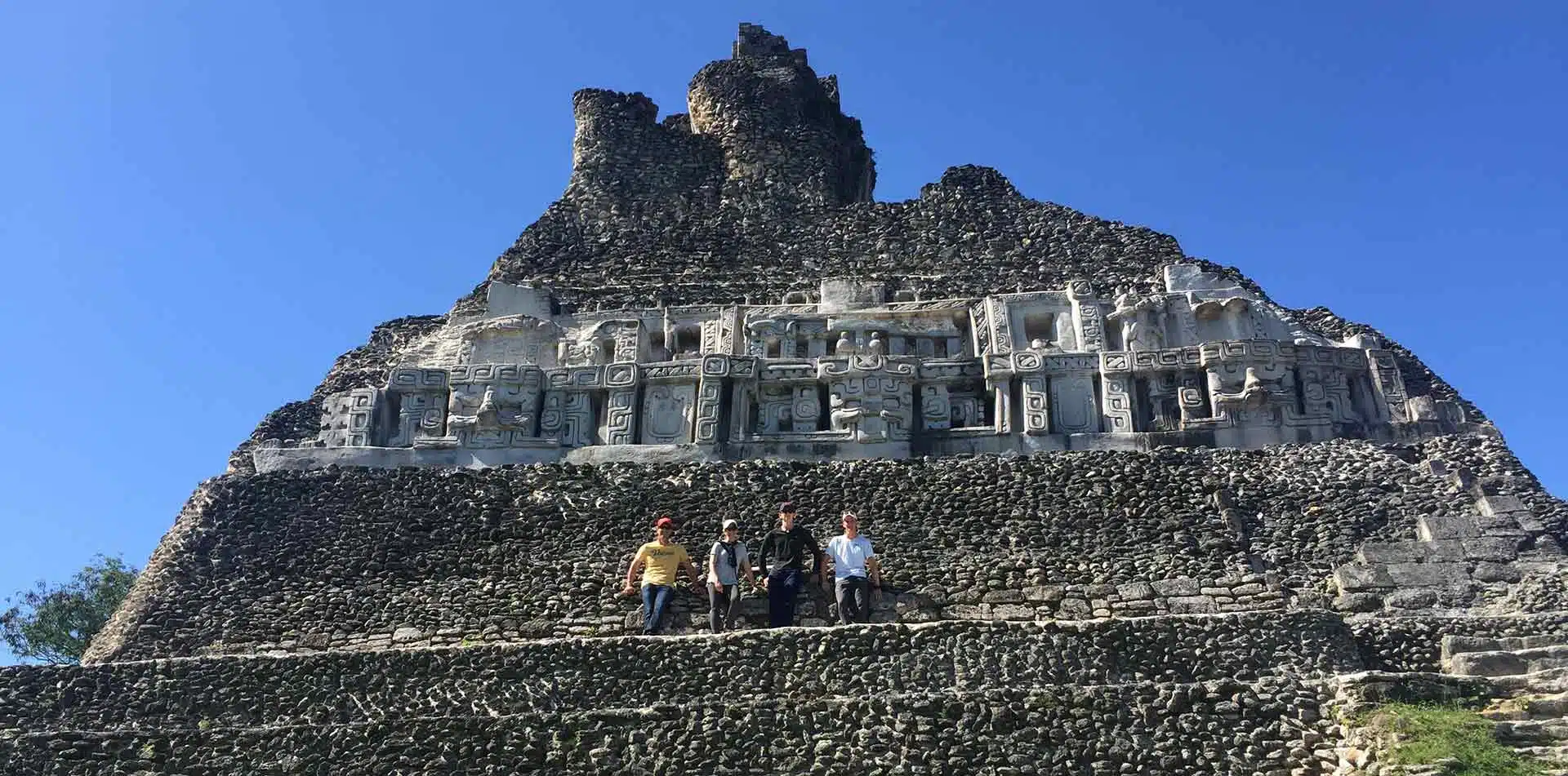 Central America Belize group posing ancient Mayan ruins historical architecture - luxury vacation destinations