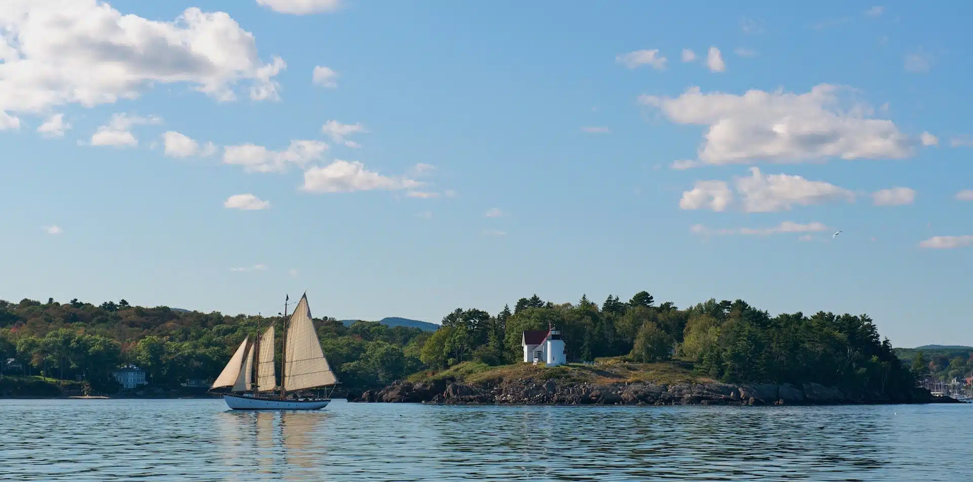 North America United States Maine Camden, Maine outer harbor with Curtis lighthouse and sailing ship