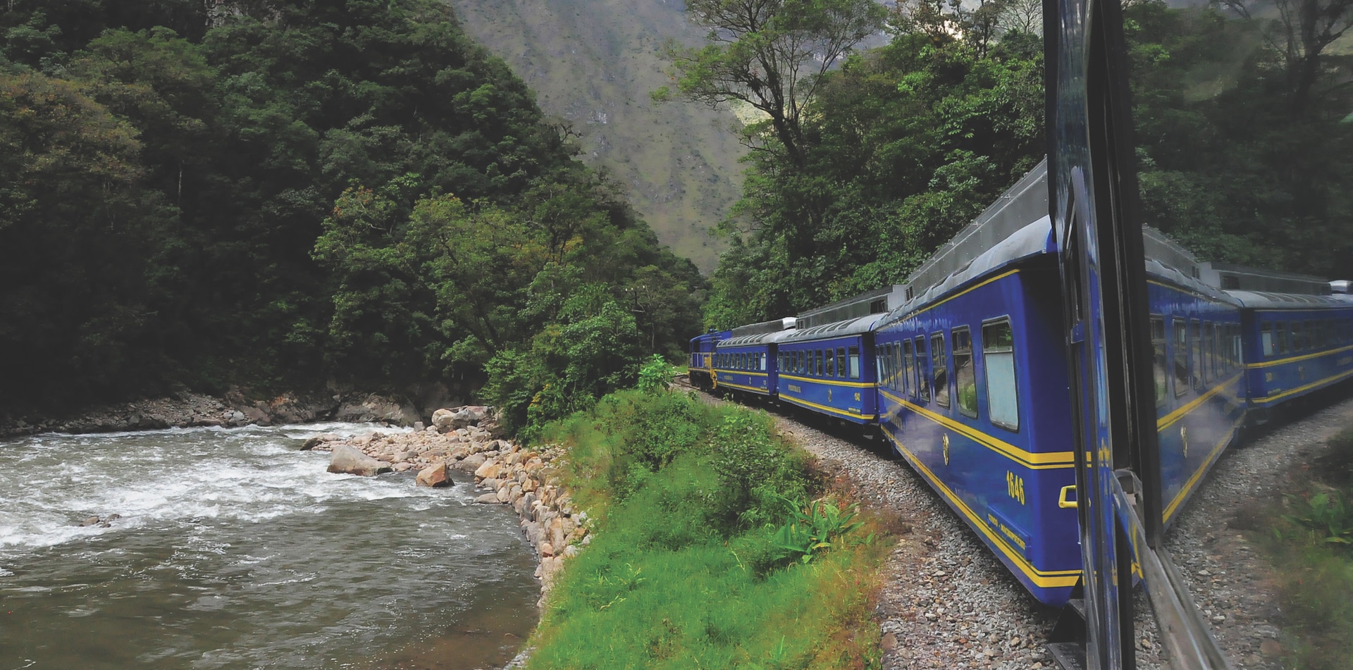 Peruvian train curving along the track amid mountains