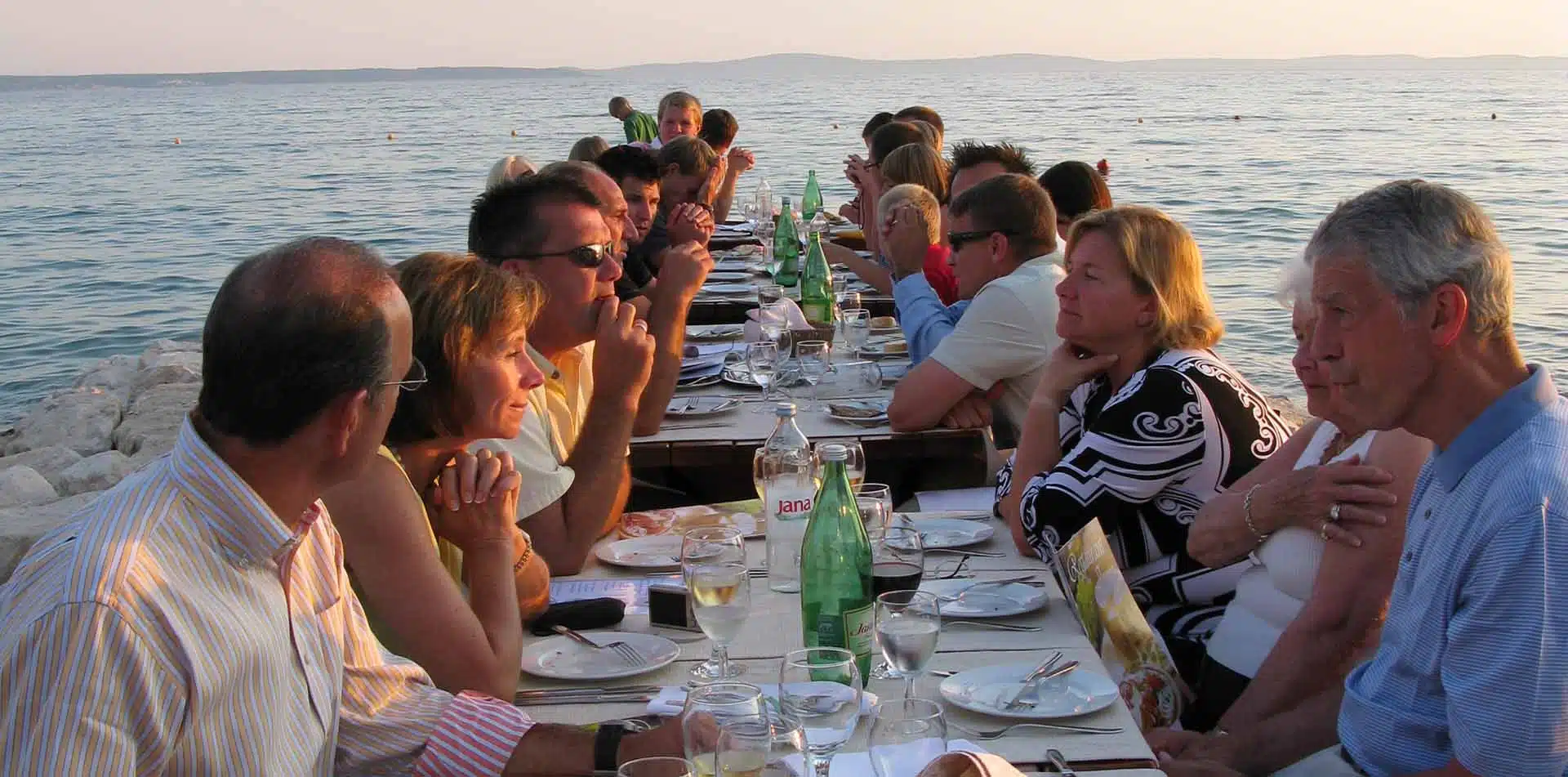 Group Eating Dinner Al Fresco Near Beach