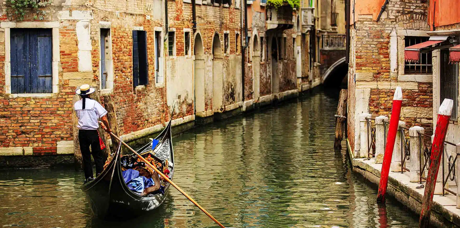 Man on Gondola in Canals of Venice, Italy