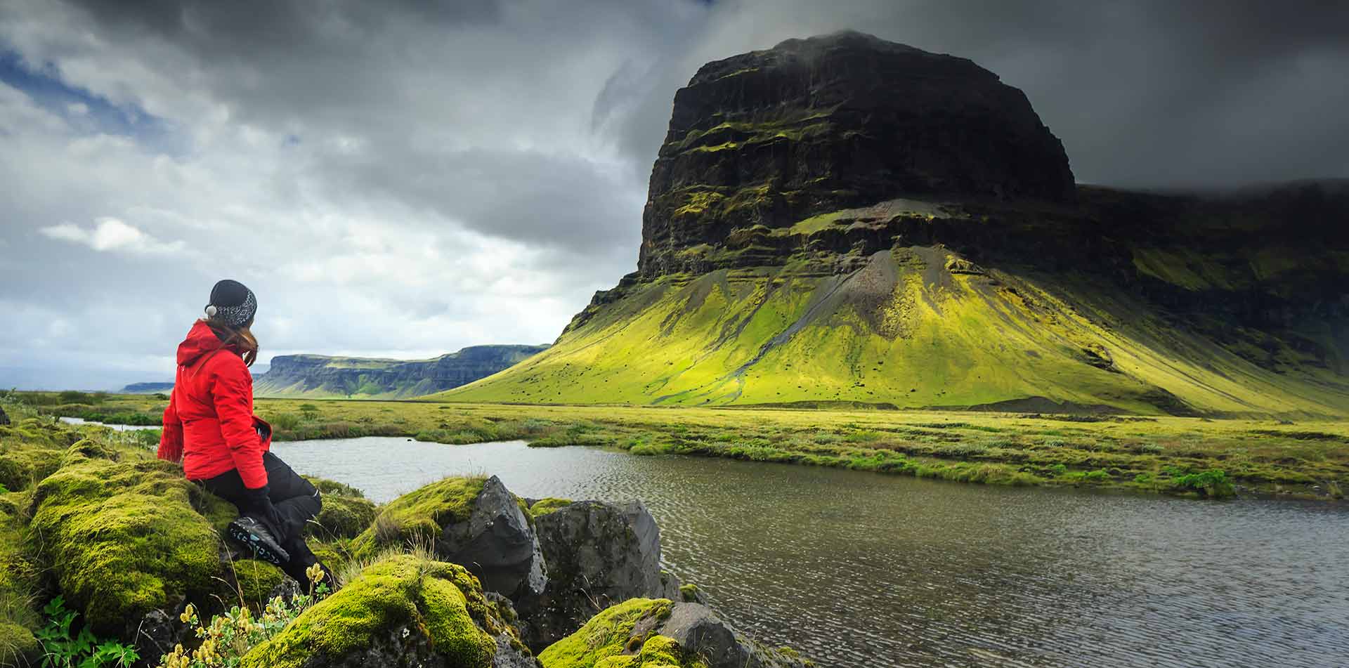 Traveler soaking in the dramatic landscape in Iceland