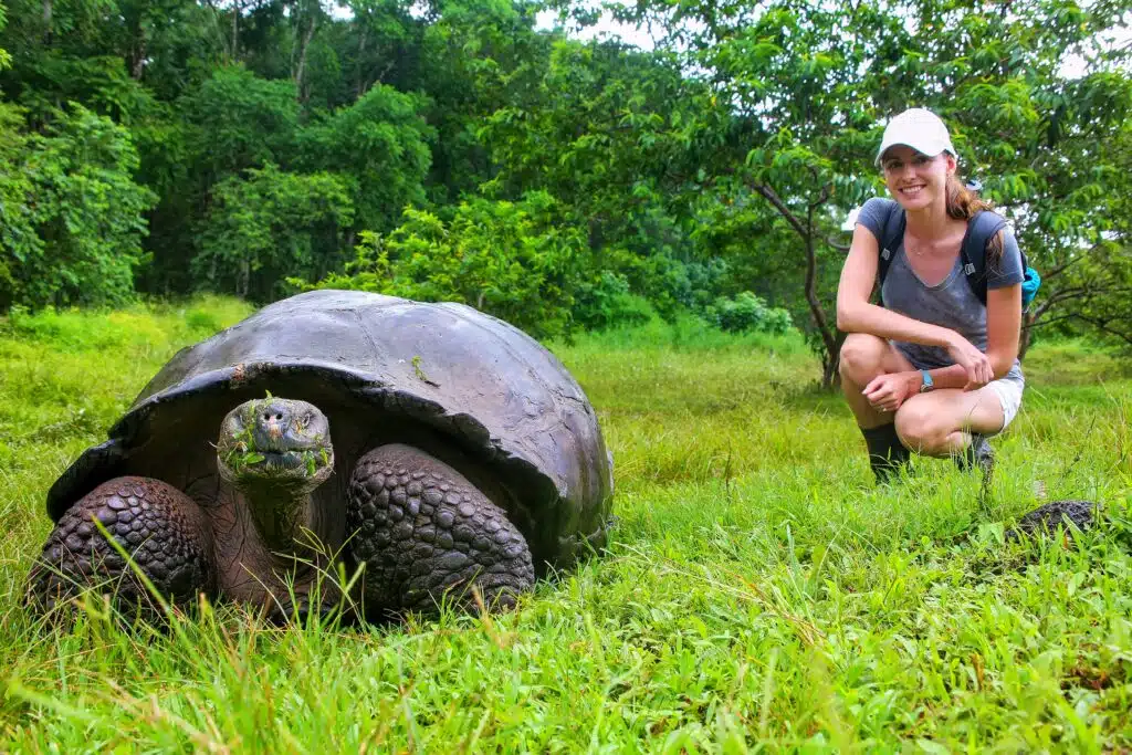 Woman with giant land tortoise in the Galapagos