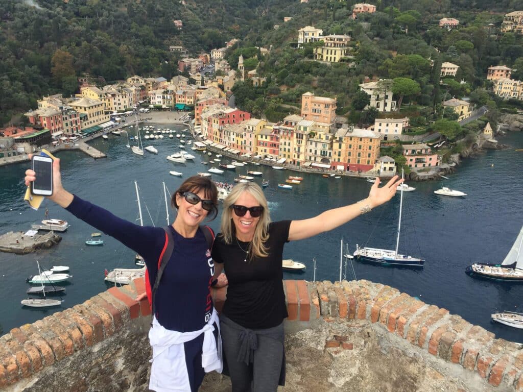 Women in Portofino waving from Castello