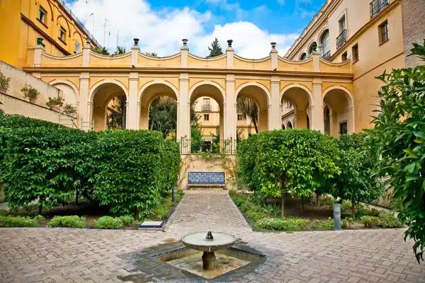 Courtyard with trees and a fountain in the Alcázar of Seville