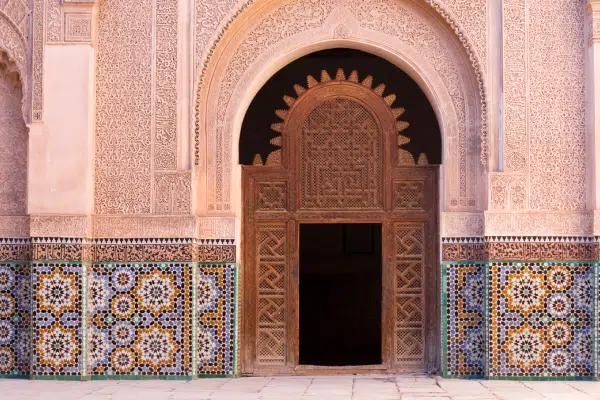 An intricate doorway and tiled walls of Hassan II Mosque in Casablanca, Morocco
