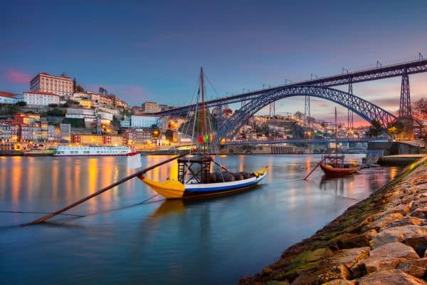 Rabelo boats in the Douro River with the cityscape of Porto in the background