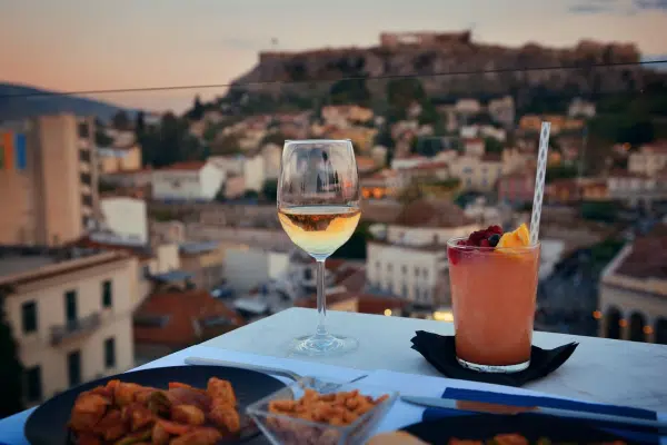 Sip on some Greek drinks, including Ouzo and Frappe while overlooking the city of Athens, Greece.