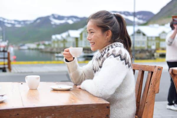 Enjoy a warm beverage in Iceland with the backdrop of snowy mountains.
