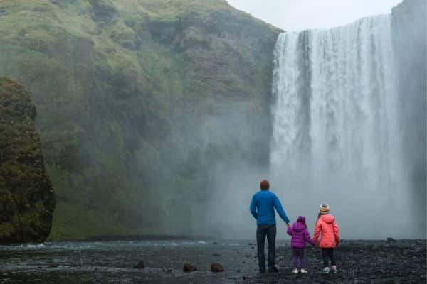 Marvel at the base of a thundering waterfall in Iceland 
