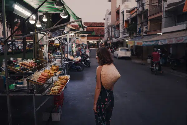 Woman walking in night market in Saigon, Vietnam